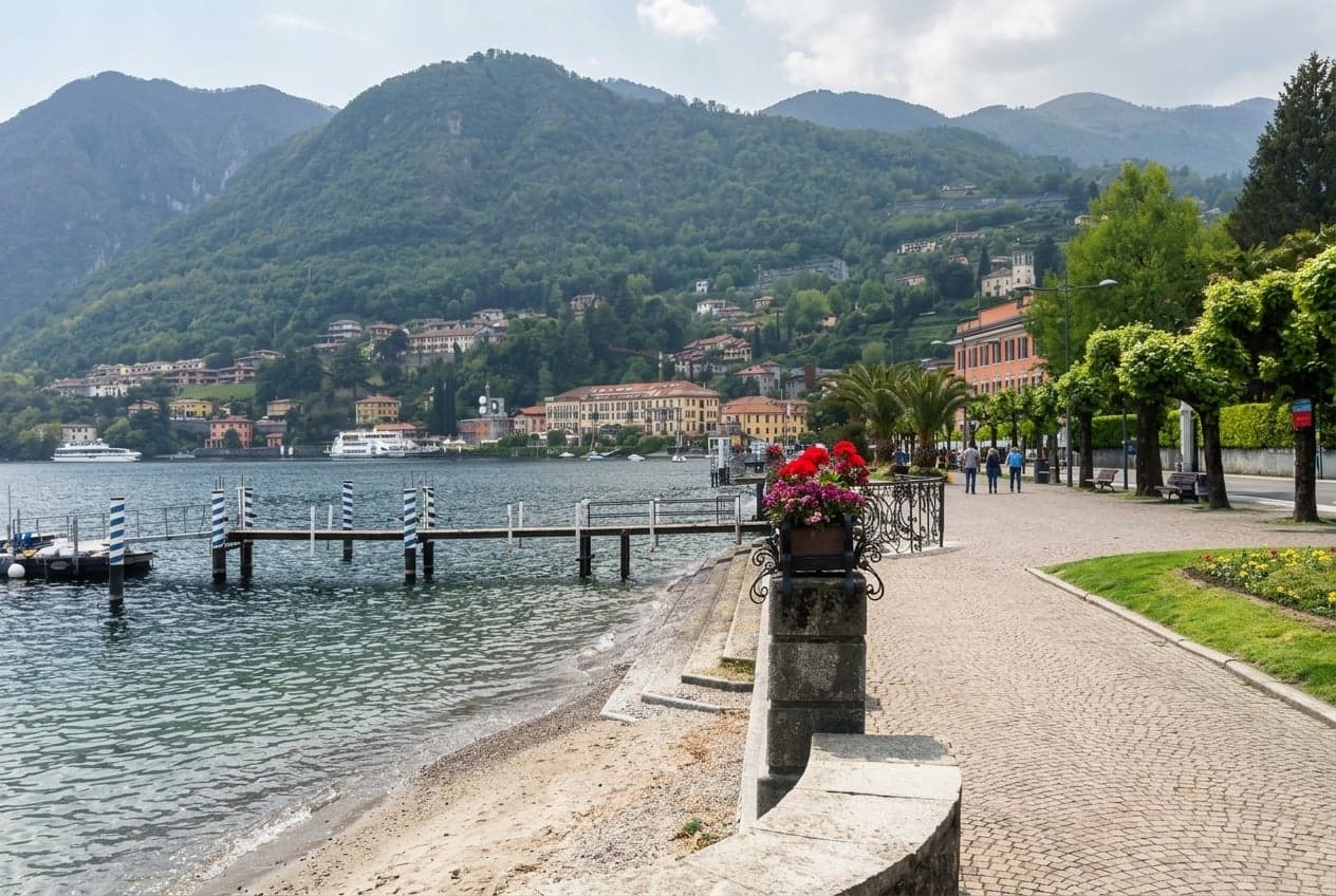 The flat Lungo Lago Benedetto Castelli promenade in Menaggio, with mooring poles and the lakefront walk