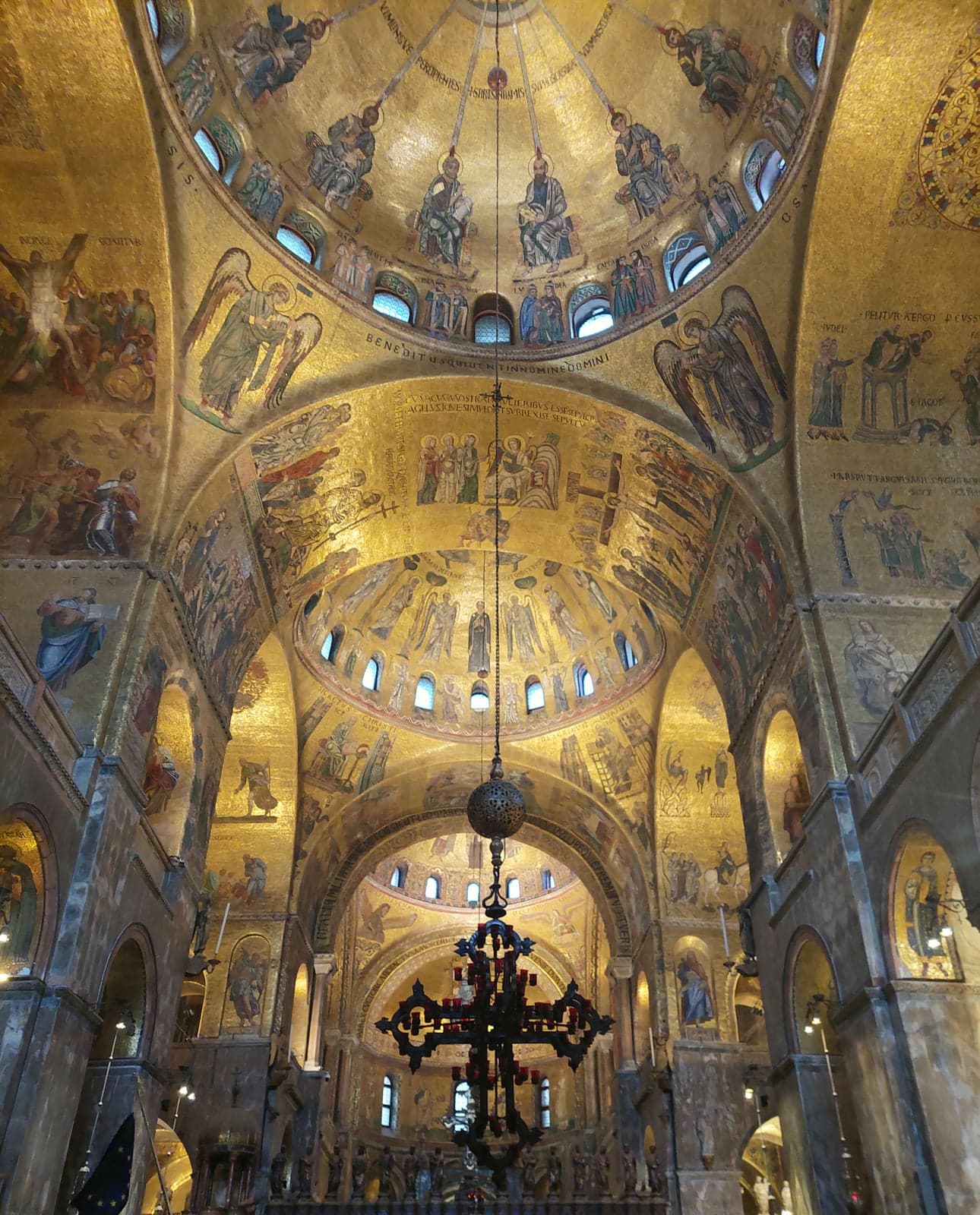 Gold mosaics covering the domes and arches inside St. Mark's Basilica, looking down the nave toward the iconostasis