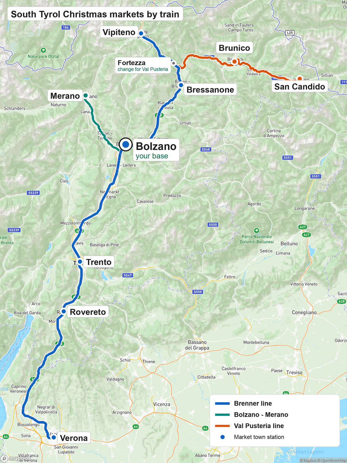 Map of the South Tyrol Christmas market towns by train: the Brenner line runs north from Verona through Rovereto, Trento and Bolzano, marked as your base, to Bressanone, Fortezza and Vipiteno; a branch runs from Bolzano to Merano; and from Fortezza the Val Pusteria line runs east to Brunico and San Candido