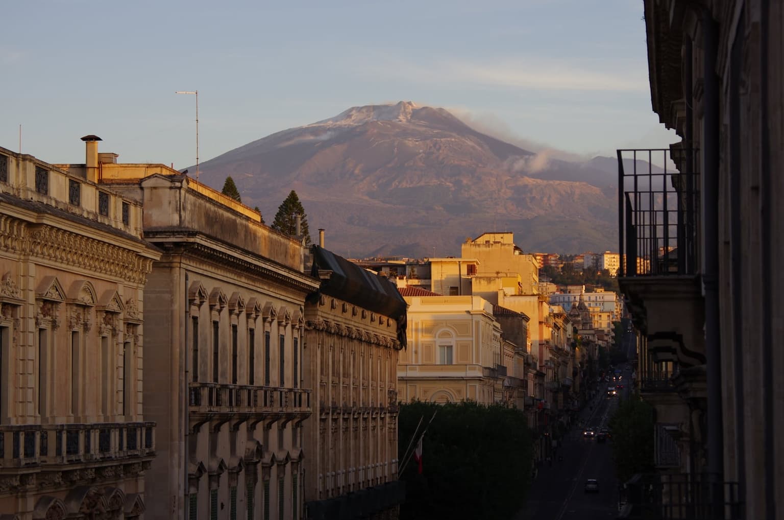 Via Etnea's straight run north in Catania, Sicily, with Mount Etna rising at the end of the street